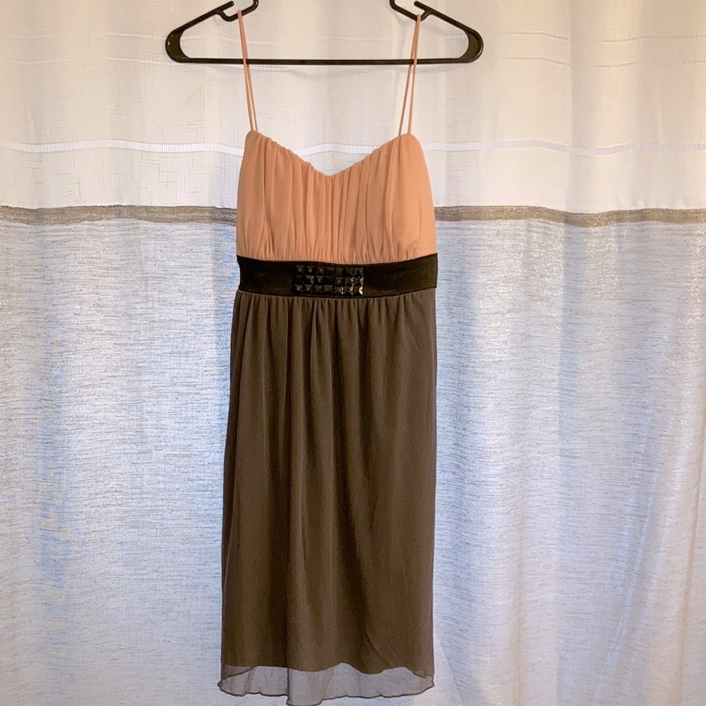 Cute pastel gray, with a pastel pink upper layer, dress. Black studs in the mid